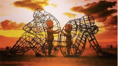 Children in wire cages shaped like bodies touching hands.